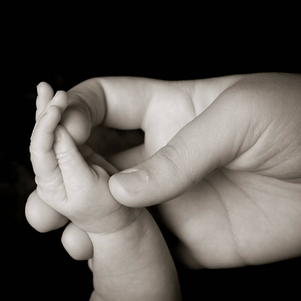 istock Babys Fingers Black and White 179272140