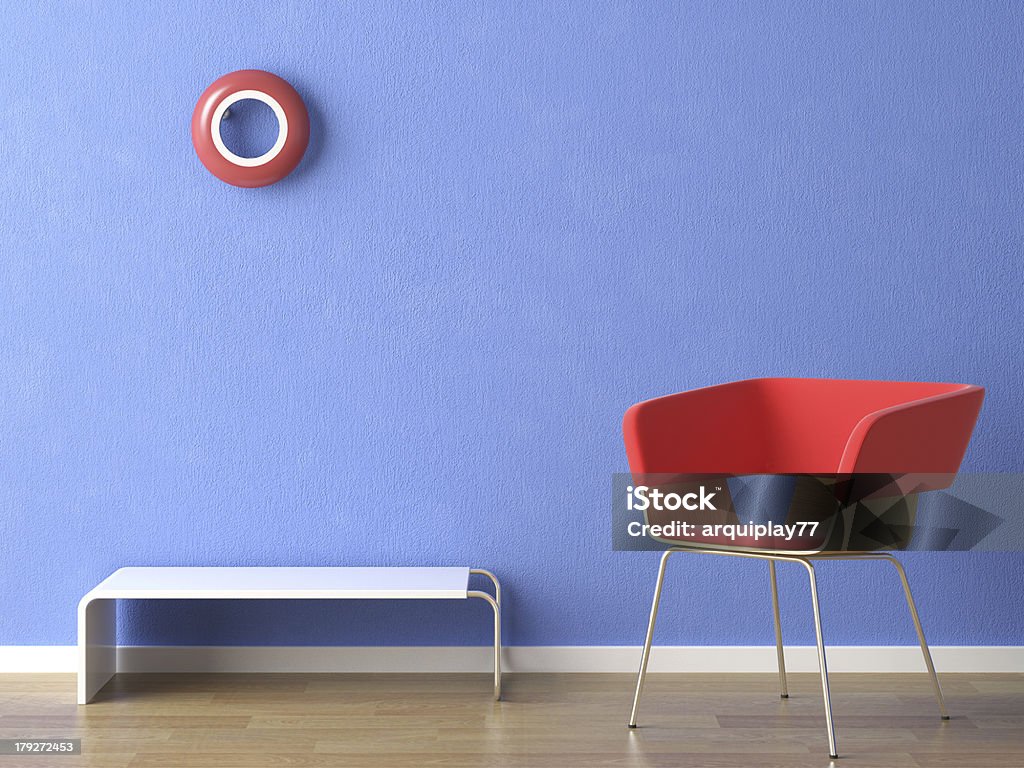 red chair on blue wall "red chair, lamp and table on blue wall" Living Room Stock Photo