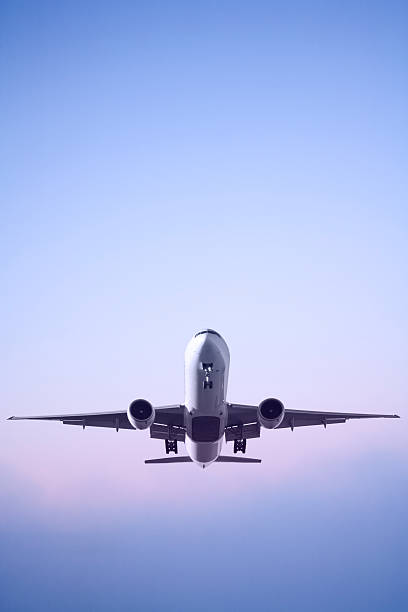 A jet airplane in landing sequence during dawn