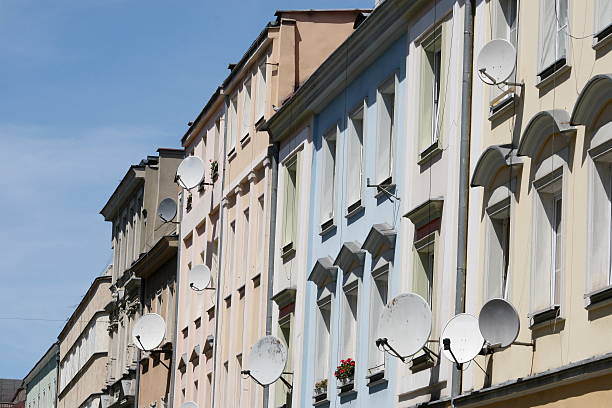 old buildins and new satellite dishes  stock photo