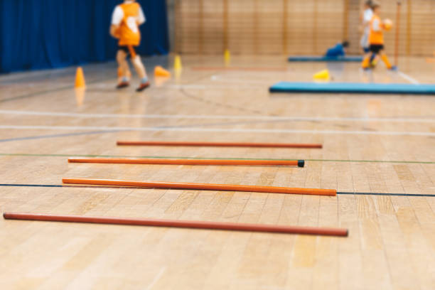 istock Futsal training field with orange poles yellow cones and red hurdles. Physical education. Futsal training field. Indoor football practice for children. Indoor soccer training during the winter 1792734248