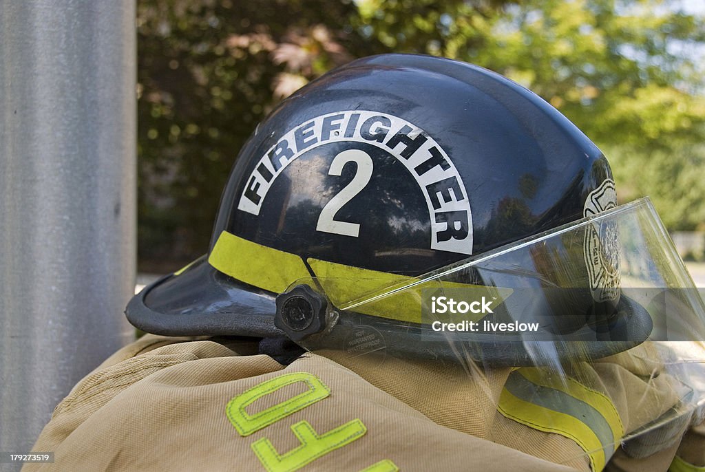 firefighter's helmet Fireman's helmet on coat. Black Color Stock Photo