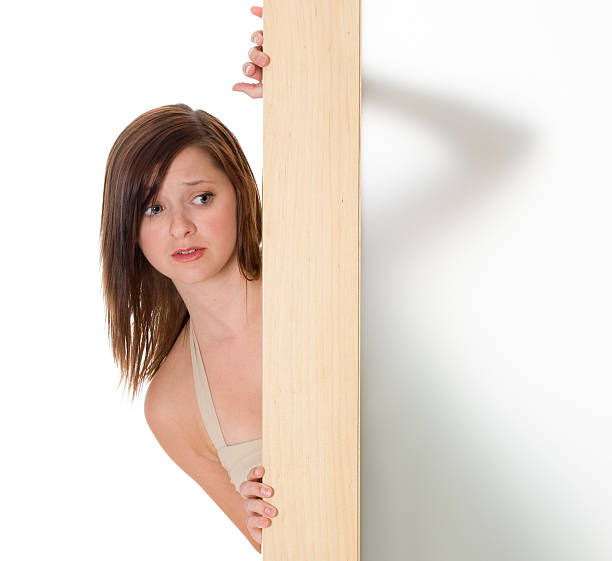istock Frightened Red Headed Woman Looks Outside 179273885