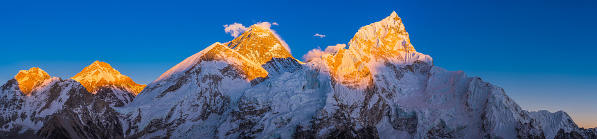 Mt. Everest 8848m and Nuptse 7861m illuminated by the warm light of the setting sun high above the Khumbu glacier and Everest Base Camp in the Himalayan mountains of Nepal.