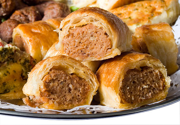Mini Sausage Rolls Mini party sausage rolls on a platter with savoury meatballs and quiche food service occupation food and drink industry party buffet stock pictures, royalty-free photos & images