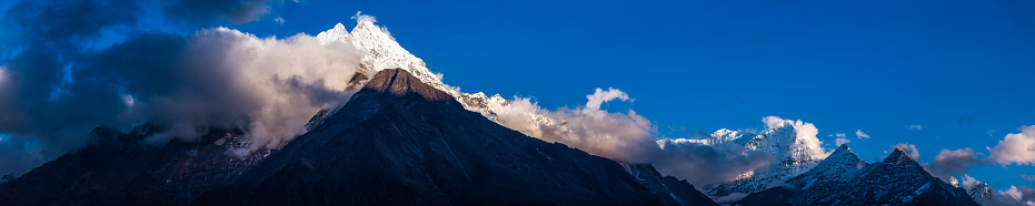 The jagged snow capped peaks of Thamserku 6608m soaring high in the Himalayan mountains of Nepal.