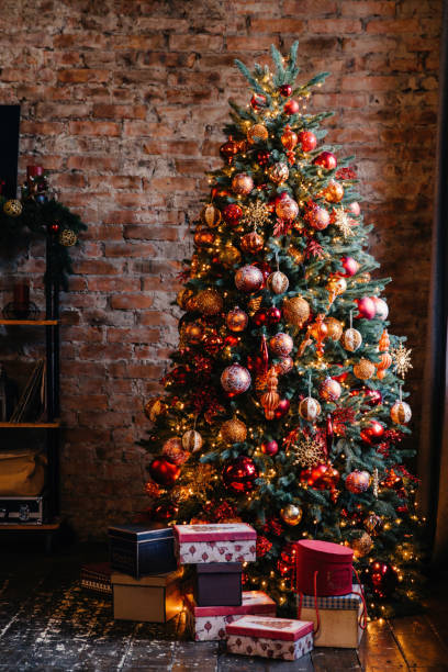 istock Ornate Christmas tree with a rich array of red and gold decorations, nestled in a rustic setting with gifts 1792747813