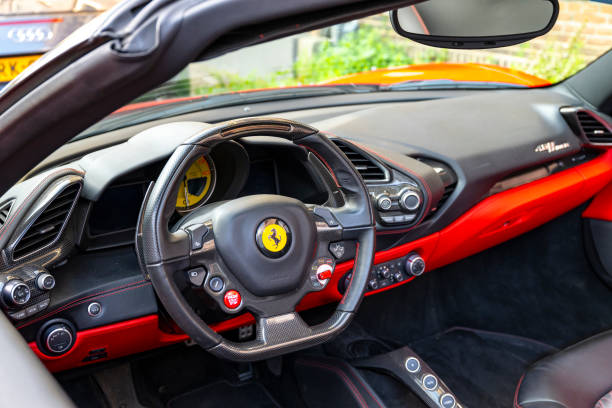 Red Ferrari 488 Spider sports car parked on the street in Zwolle, The Netherlands. The Ferrari 488 GTB (Tipo F142M) is a mid-engined sports car powered by a 3.9-litre twin-turbocharged V8.