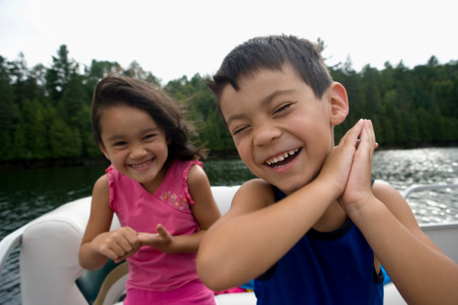 Two happy children on a boat.