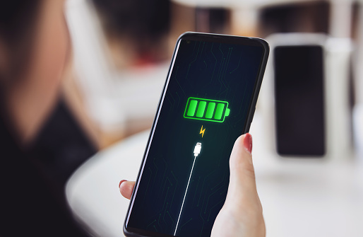 Mobile phone screen notifies of full battery Charging success by plugging in the smartphone with a power charger, or power bank. Energy technology concept, convenience of modern power system