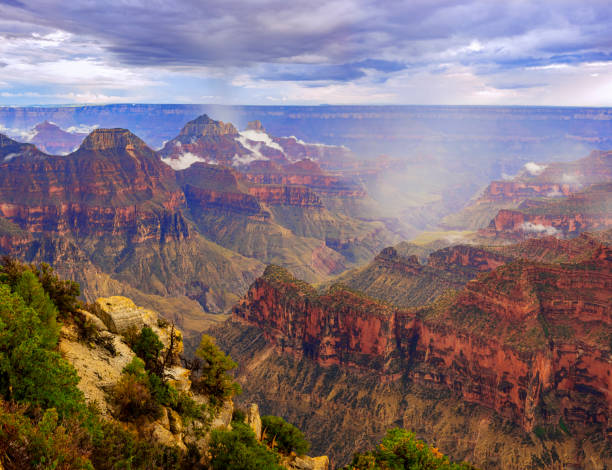 The Grand Canyon Lodge overlooks a North Rim cliff edge of Grand Canyon National Park, Arizona, USA. Built on a plateau overlooking the rock formation landscape, the hotel, restaurant, and cabins are a travel destination for American Southwest tourism. The building is a famous place for viewing majestic, scenic nature. 