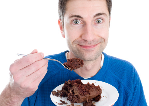 A man enjoying chocolate cake!
