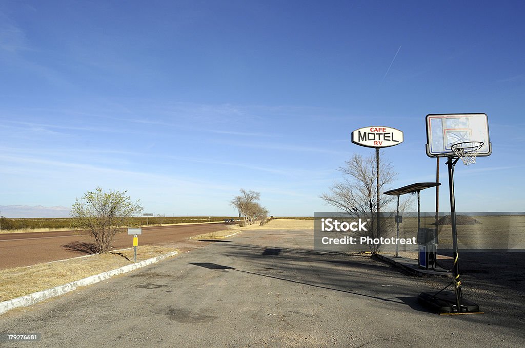 Sign of Roadside Motel and Cafe "Sign of an old roadside Motel and Cafe, with a basketball court, on an endless straight road crossing the expansive prairie in the U.S. West" Desert Area Stock Photo