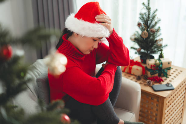 istock Asian woman feeling lonely sitting alone on Christmas day and thinking about problem. 1792773835