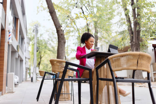 istock Smiling woman having a coffee at the caffe while banking on her device 1792777655