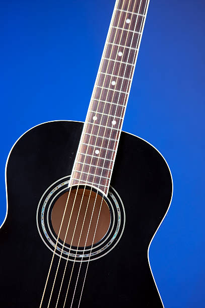 istock Black Acoustic Guitar On Blue 179279117