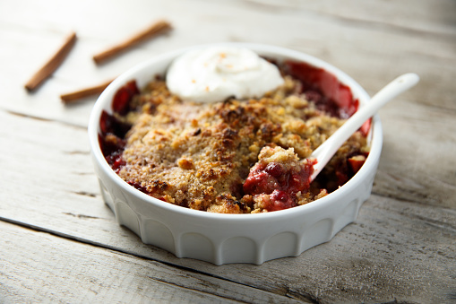 Traditional homemade berry crumble with cream