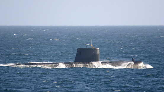 Front view of a submarine sailing under the sea in close-up of a three-dimensional render image