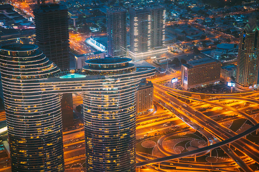 Dubai, UAE, United Arab Emirates - May 25, 2021: Aerial Bird's-eye View Of Dubai Cityscape Skyline. Night Traffic In Residential District. Street Night Yellow Illumination In Dubai. High quality photo.