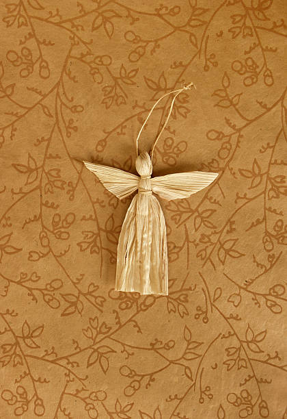 straw angel  on ornated background stock photo