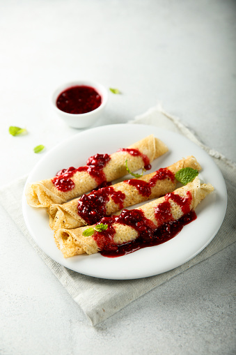 Homemade crepes with raspberry sauce