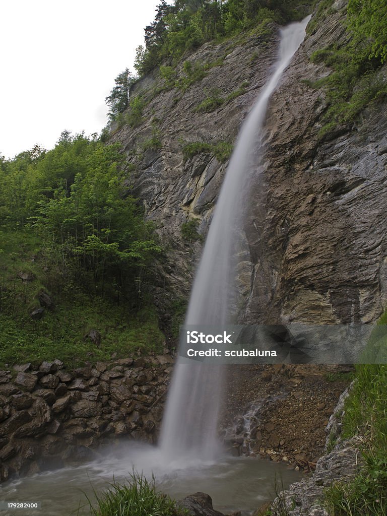 Waterfall (Dundelbachfall/Lungern) Outdoor wide angle long exposure photography from a big waterfall. Back Lit Stock Photo