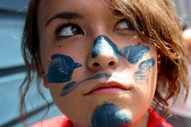 istock Girl with paint on face while painting 179282942