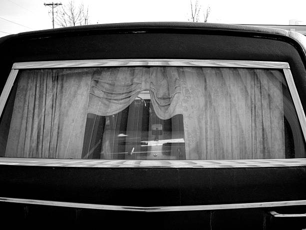 Rear window of a hearse or funeral coach "I found this old hearse in Lowell, Michigan and had to photograph it." hearse photos stock pictures, royalty-free photos & images