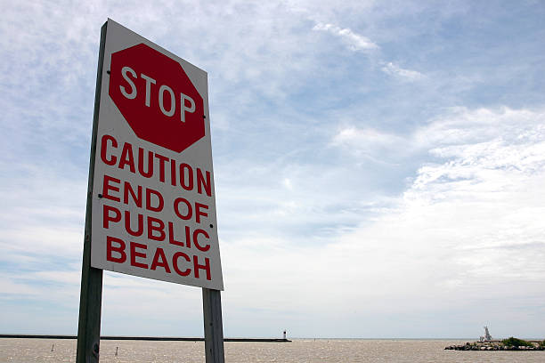 stop sign, caution end of beach stock photo