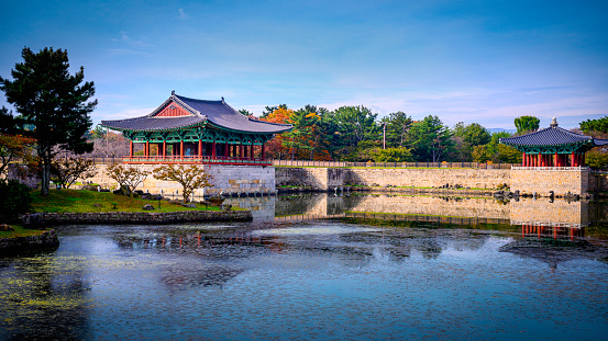 The iconic spire of Namsan Tower overlooking tourists visiting the traditional wooden homes of Bukchon Hanok village in Seoul, South Korea’s vibrant capital city.