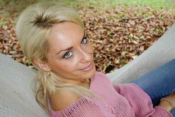 Portrait of blonde girl in autumn landscape. stock photo