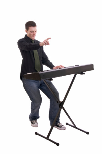 Male keyboard player on white background.