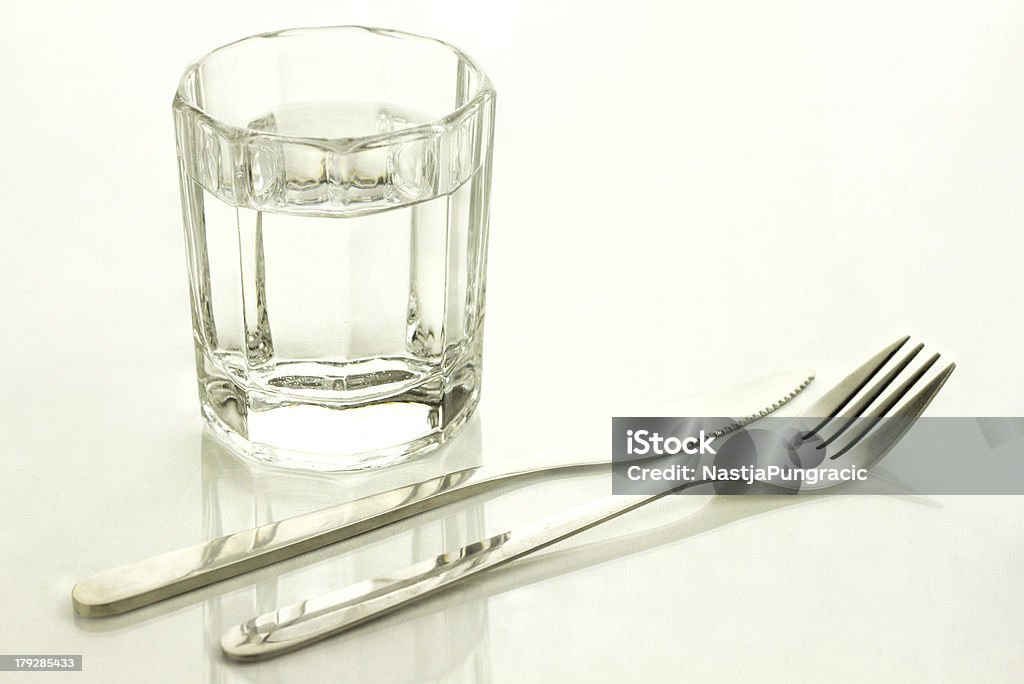 Knife and fork with a glass of water "Glass of water, knife and fork" Fasting - Activity Stock Photo