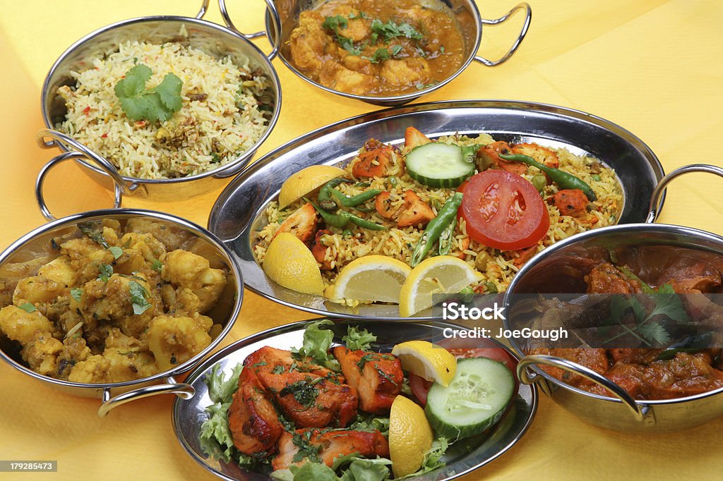 Indian Curry Meal "Selection of Indian curry dishes including chicken tikka, biriani, pilau rice, lamb and vegetable curries." Culture of India Stock Photo