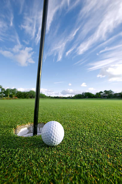 istock golf ball near pin and cup 179285481