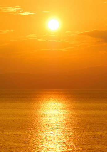 Image shows the sun setting over the Mediterranean sea