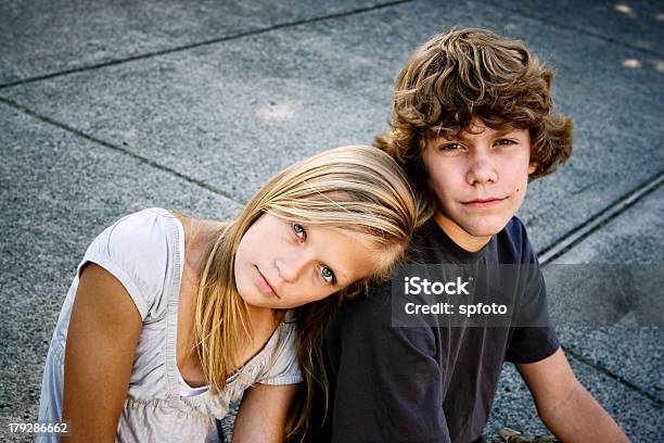 Sister Rests Her Head On Brothers Shoulder In Family Photo Stock Photo - Download Image Now