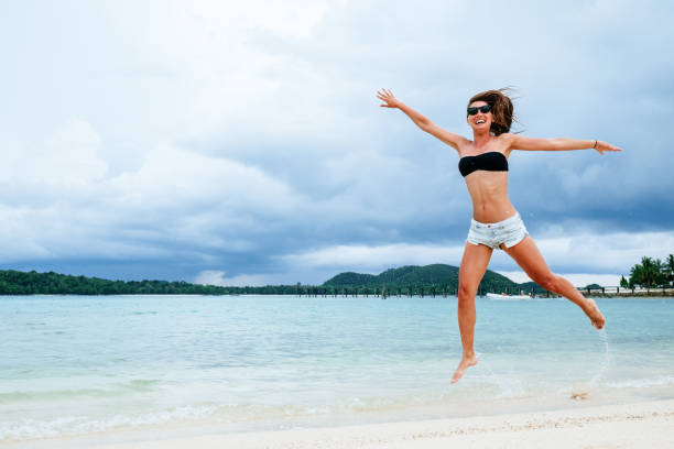 istock Funny woman playing on the beach 1792867238