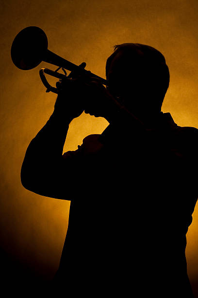 istock Trumpet Player Silhouette Yellow 179287058