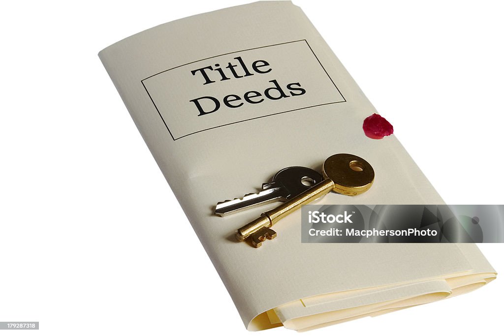 Law: Title Deeds and Keys Representation of property title deeds and house keys. Deed Stock Photo