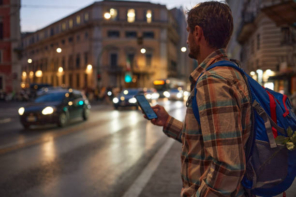 istock Young male tourist using phone while exploring big city 1792881093