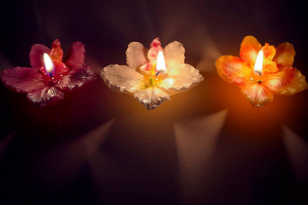 Three candles in a row stock photo