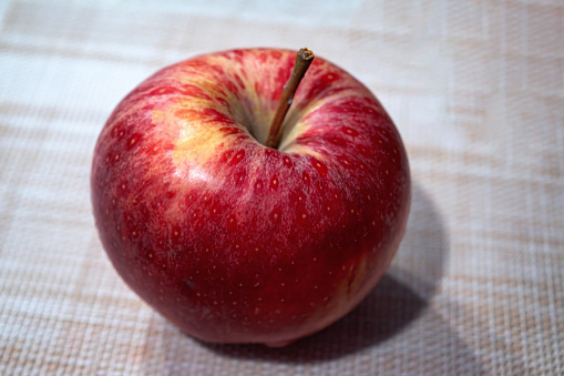 Beautiful Red apple on wooden table, closeup
