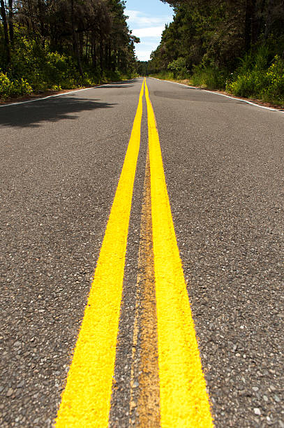 istock Double yellow lines on road into the distance 179288402