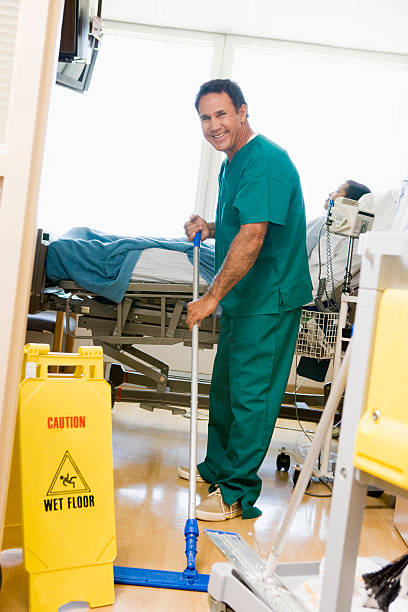 istock An Orderly Mopping The Floor In A Hospital Ward 179288713
