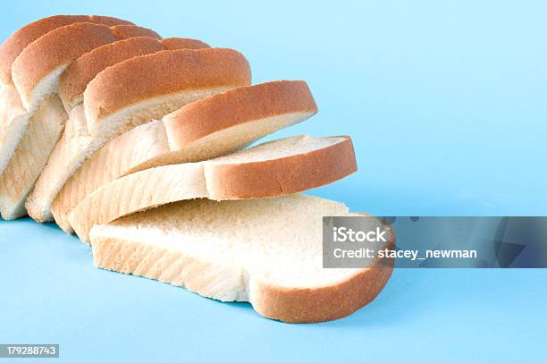 Loaf Of Sliced White Bread On Blue Background Stock Photo - Download Image Now - White Bread, Slice of Food, Stack