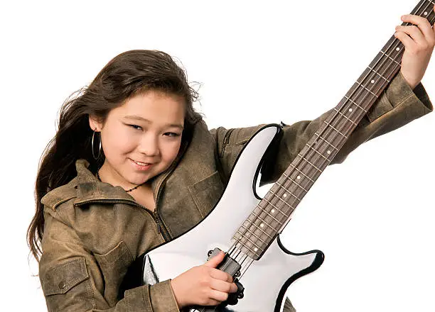 Young gyirl with electro guitar.