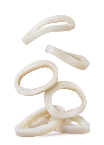 Squid rings falling on a pile close-up on a white background. Isolated