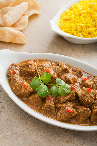 istock Indian Curry Pork Vindaloo with Poppadums and Lemon Rice 179289109