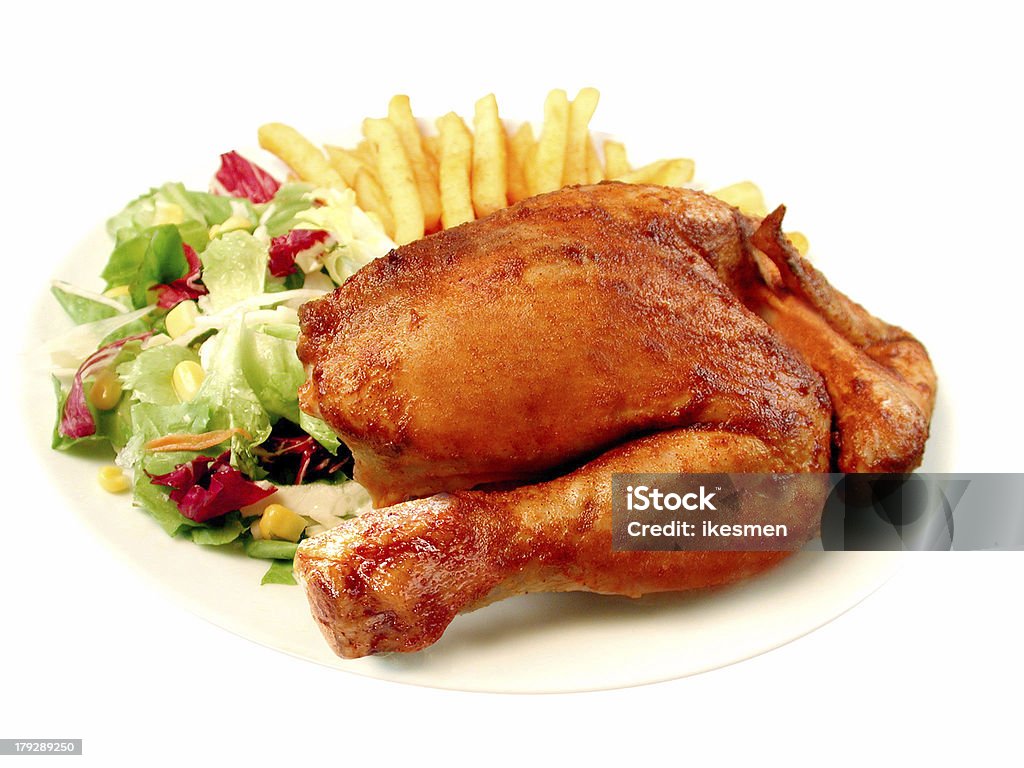 Half a roast chicken with chips and salad Crockery Stock Photo